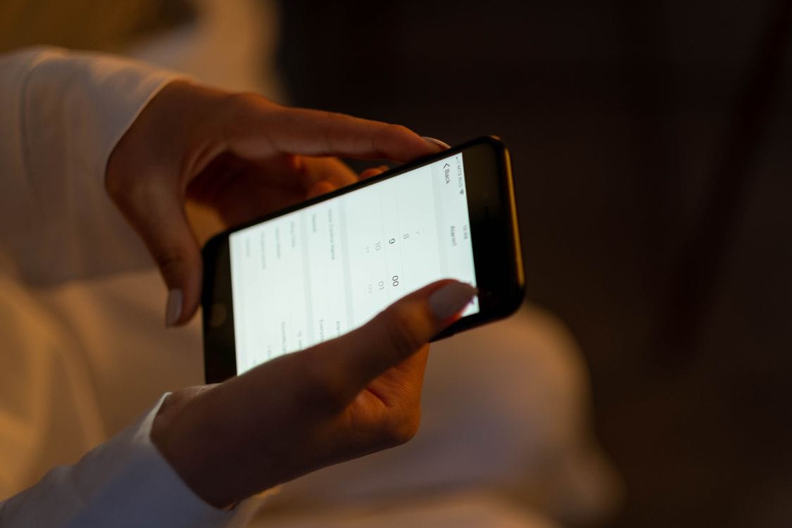 Person using a smartphone to manage a flight booking