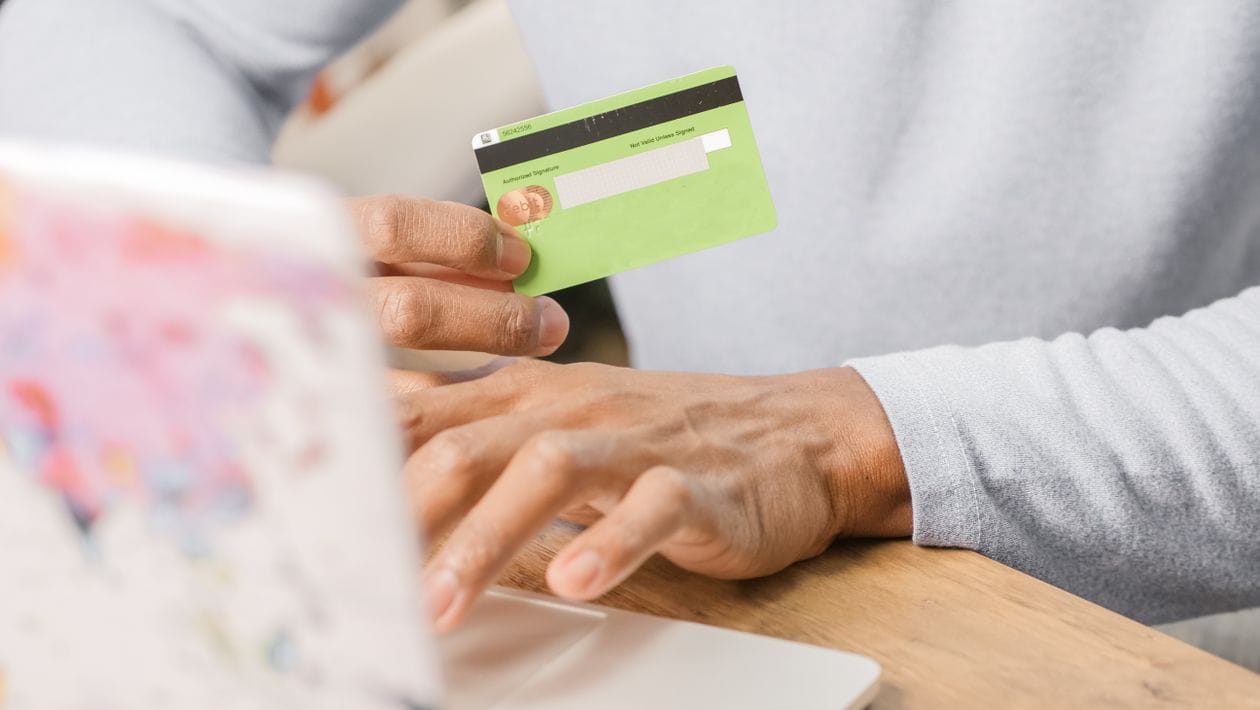 Person booking travel insurance online using a laptop