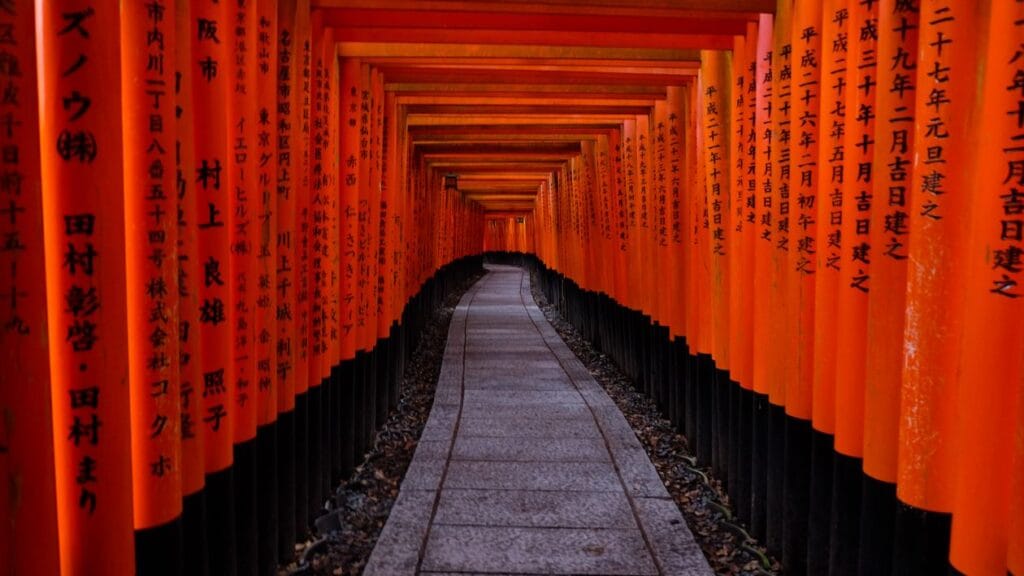 Red torii gate tunnel at Fushimi Inari Shrine in Kyoto, Japan