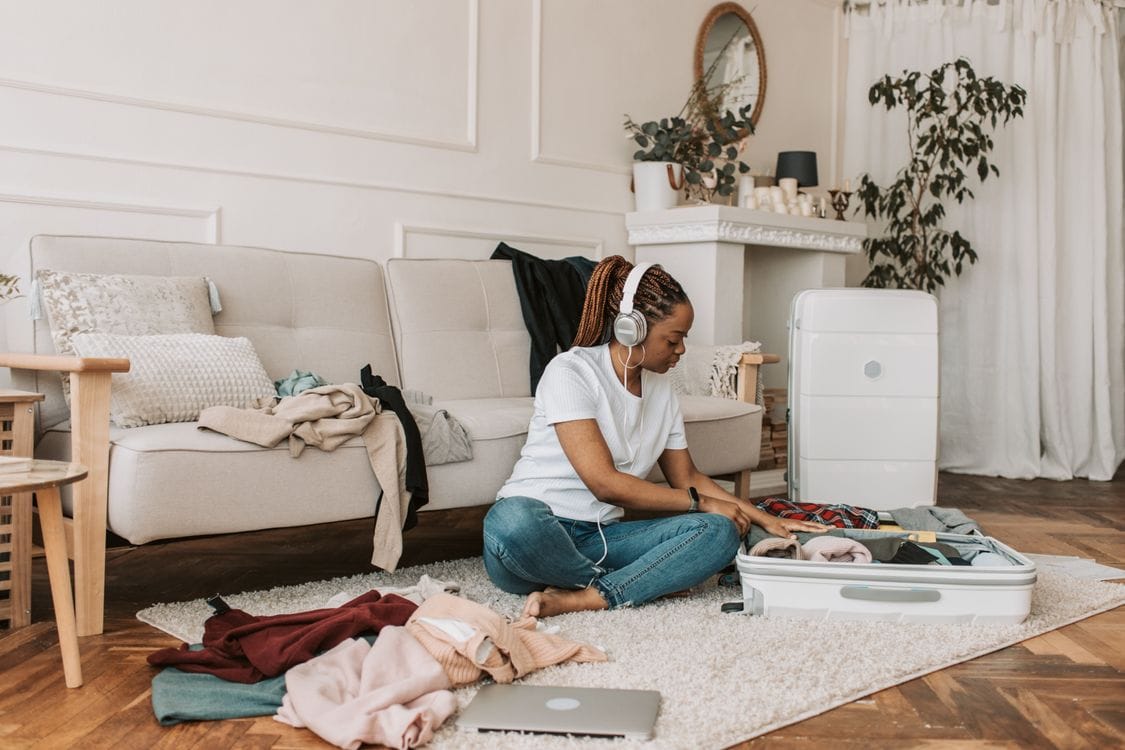 Woman packing a cabin-sized suitcase at home before a Jet2 flight