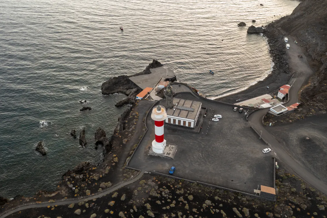 Fuencaliente Lighthouse on La Palma rocky volcanic coastline at dusk