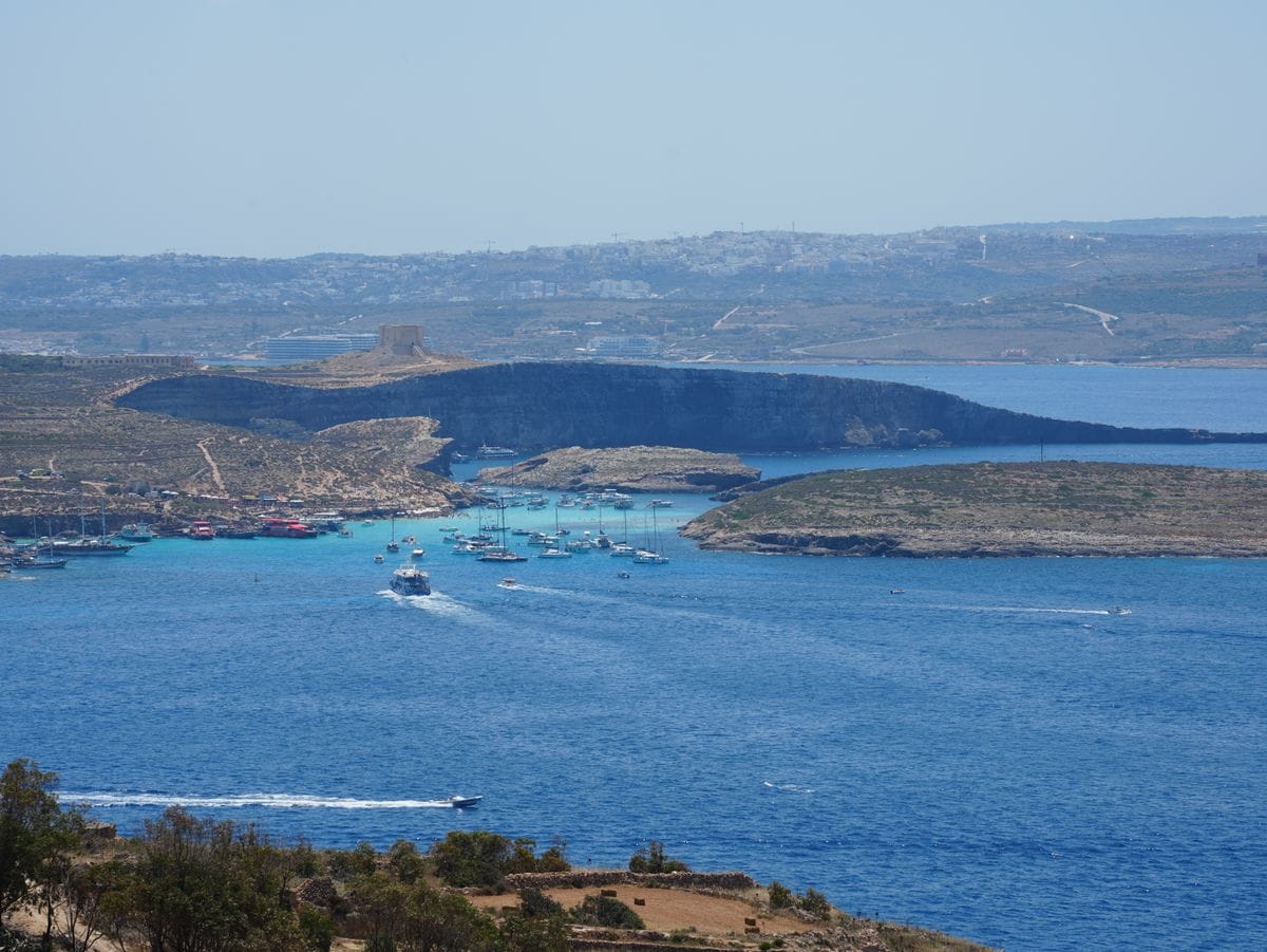 The Blue Lagoon on Comino, Malta, with turquoise water and boats