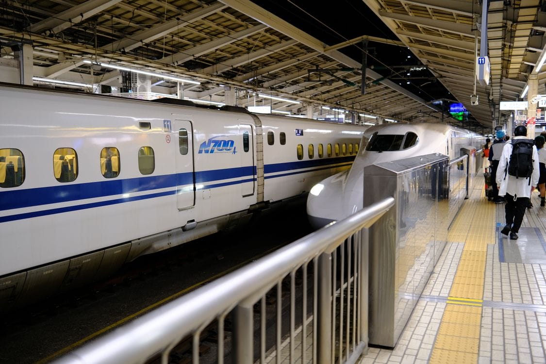 N700 shinkansen bullet train at Tokyo Station platform with passengers boarding
