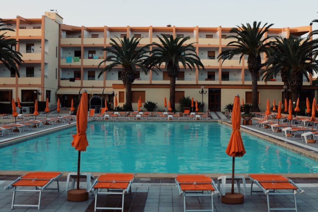 Poolside sunbeds and palm trees at a Mediterranean resort
