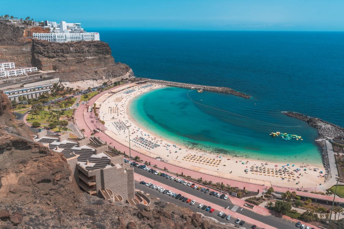Aerial view of Playa de Amadores, Gran Canaria, a sheltered horseshoe beach on the south coast and one of the island's best free beaches