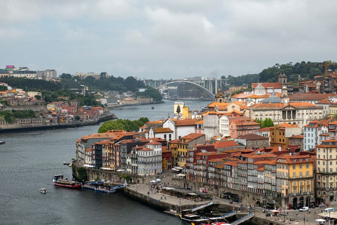 Aerial view of Porto riverside architecture showing terracotta rooftops and traditional buildings along the Douro River