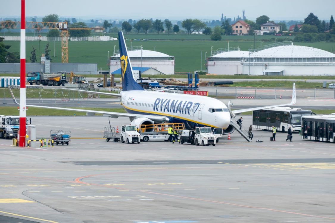 Passengers and crew preparing a Ryanair aircraft for departure