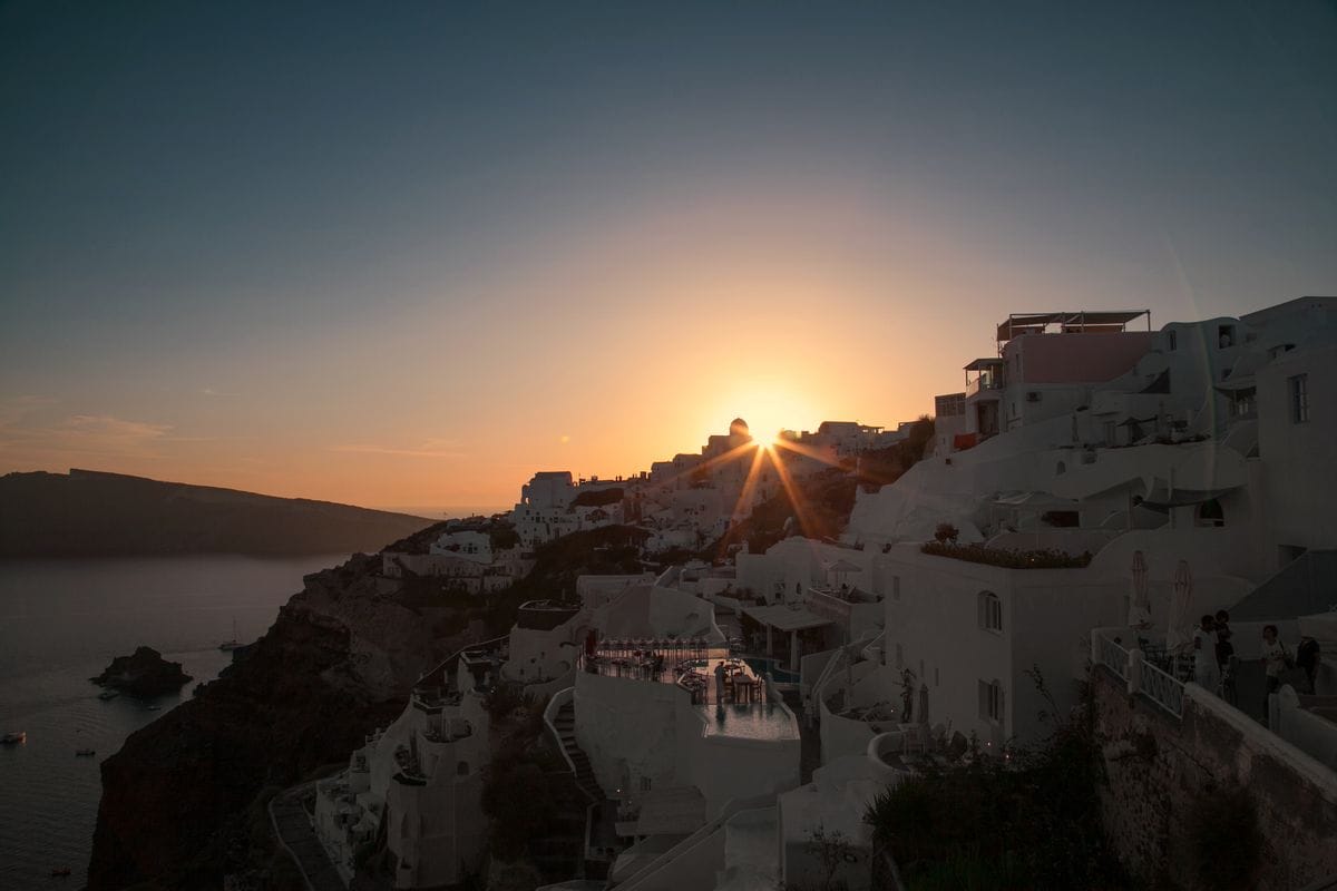 Sun setting over the whitewashed houses of Oia, Santorini