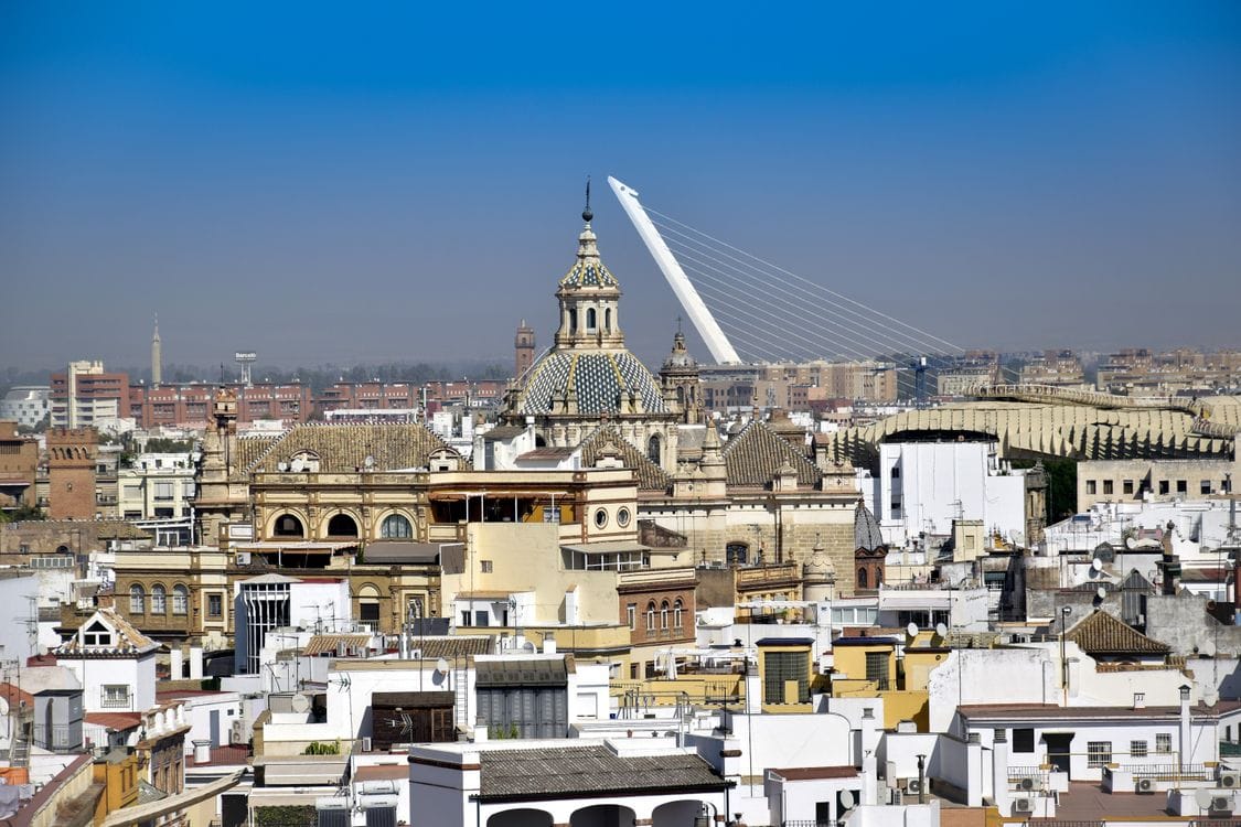 Clear blue sky over the rooftops and streets of Seville, Spain