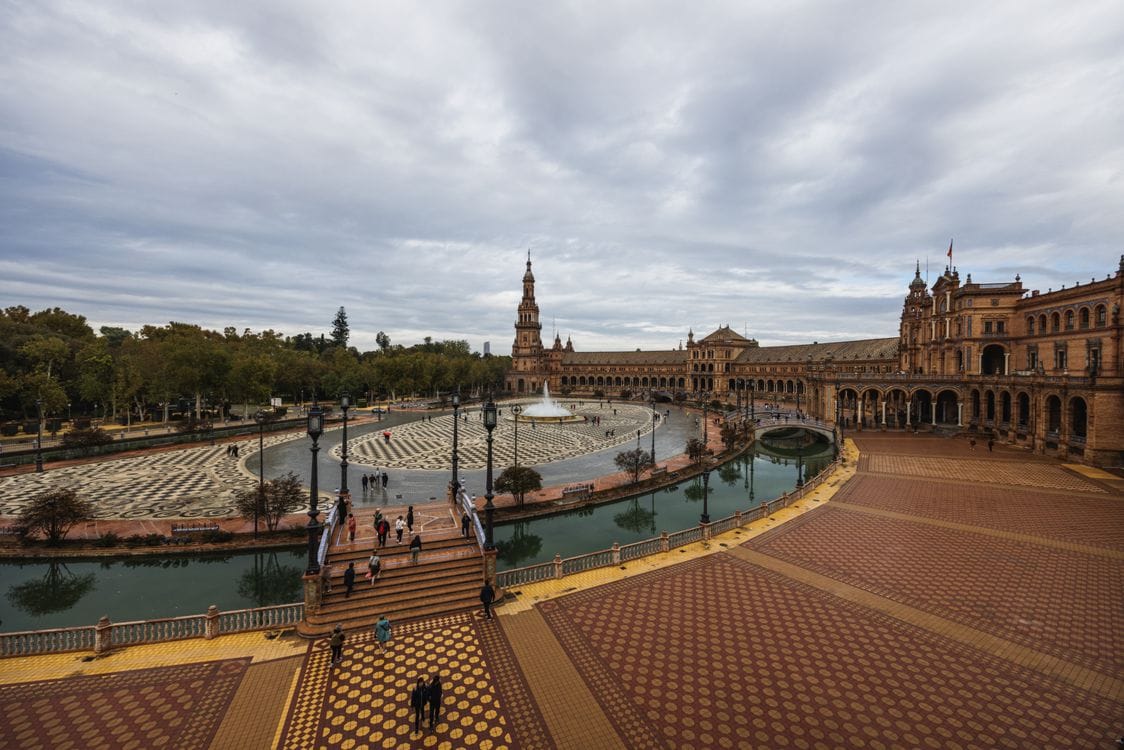 Aerial view of Plaza de España in Seville, Spain, showing the semicircular colonnaded building and canal