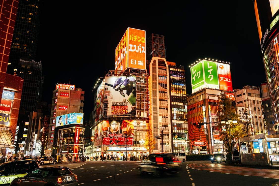 Shinjuku Tokyo cityscape at night with neon-lit skyscrapers and busy streets