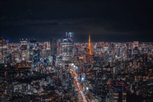 tokyo budget travel — Tokyo skyline at night with Tokyo Tower illuminated