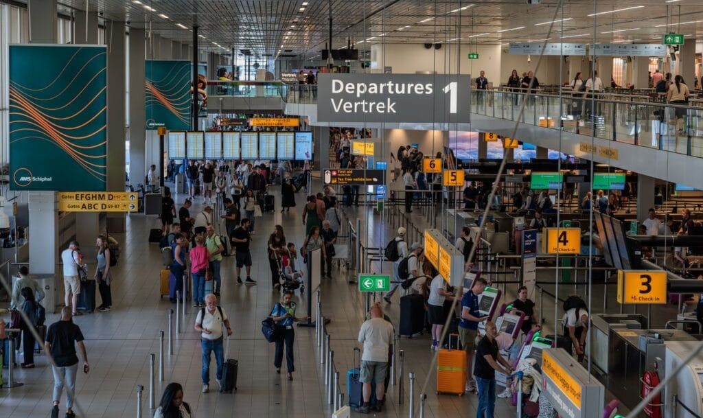 When does TUI check in open, Amsterdam Schiphol Airport busy departure hall