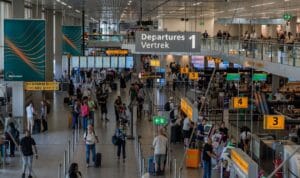 When does TUI check in open, Amsterdam Schiphol Airport busy departure hall