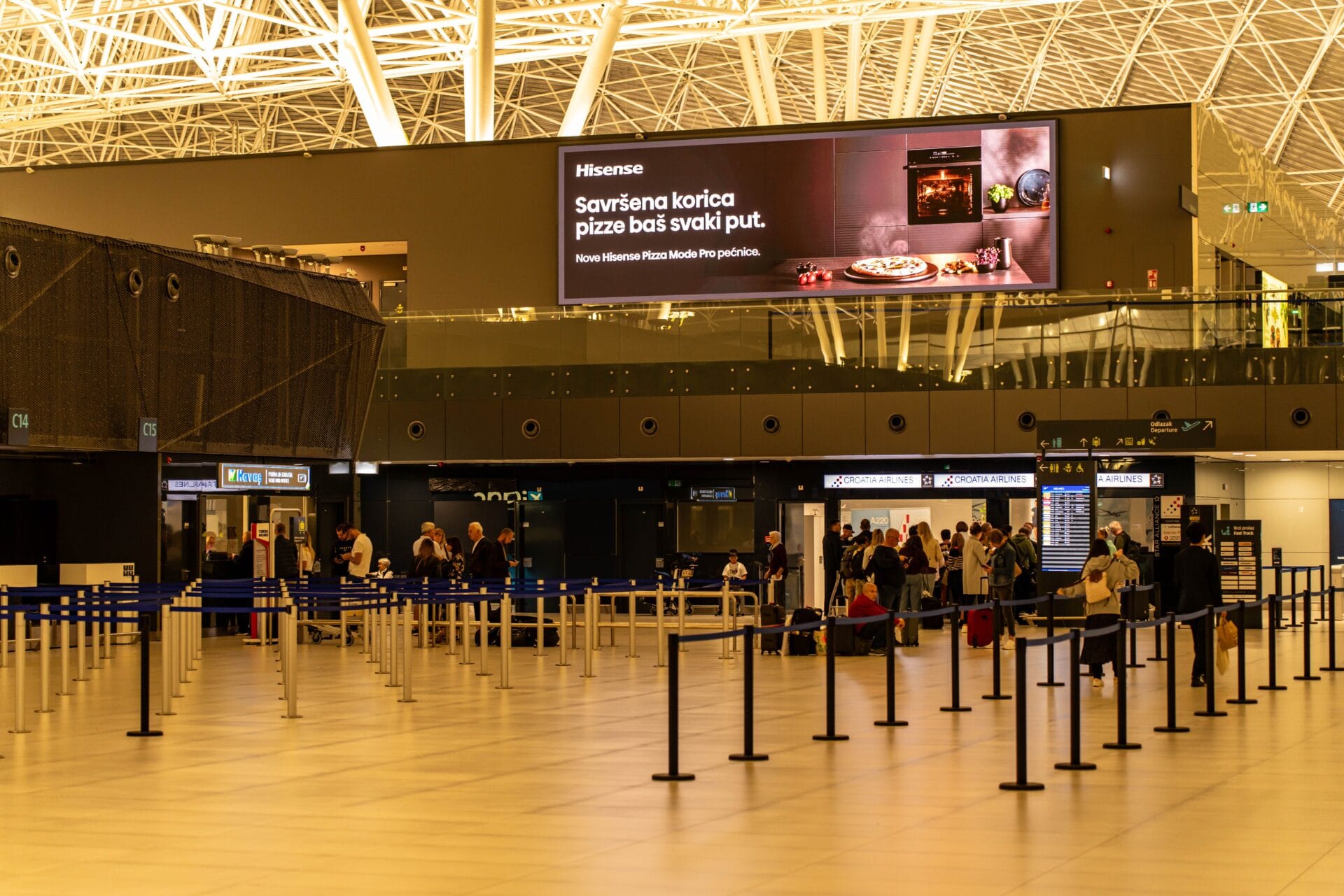 Travellers checking in at Zagreb Airport, luggage on the belt