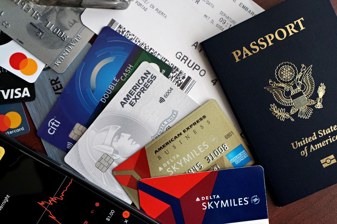 Woman at airport reviewing travel documents and boarding pass before departure