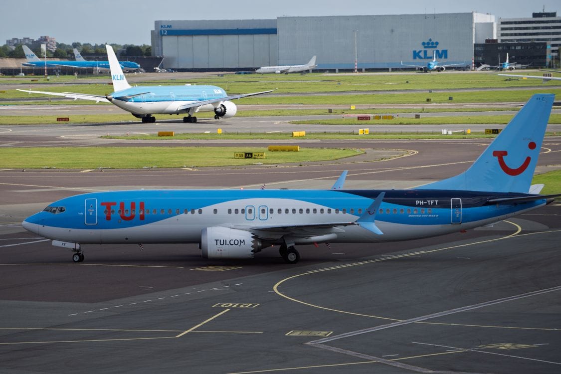 TUI and KLM aircraft on the runway at Schiphol Airport, Amsterdam