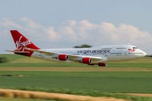 Virgin Atlantic Boeing 747 in flight over countryside on a clear day