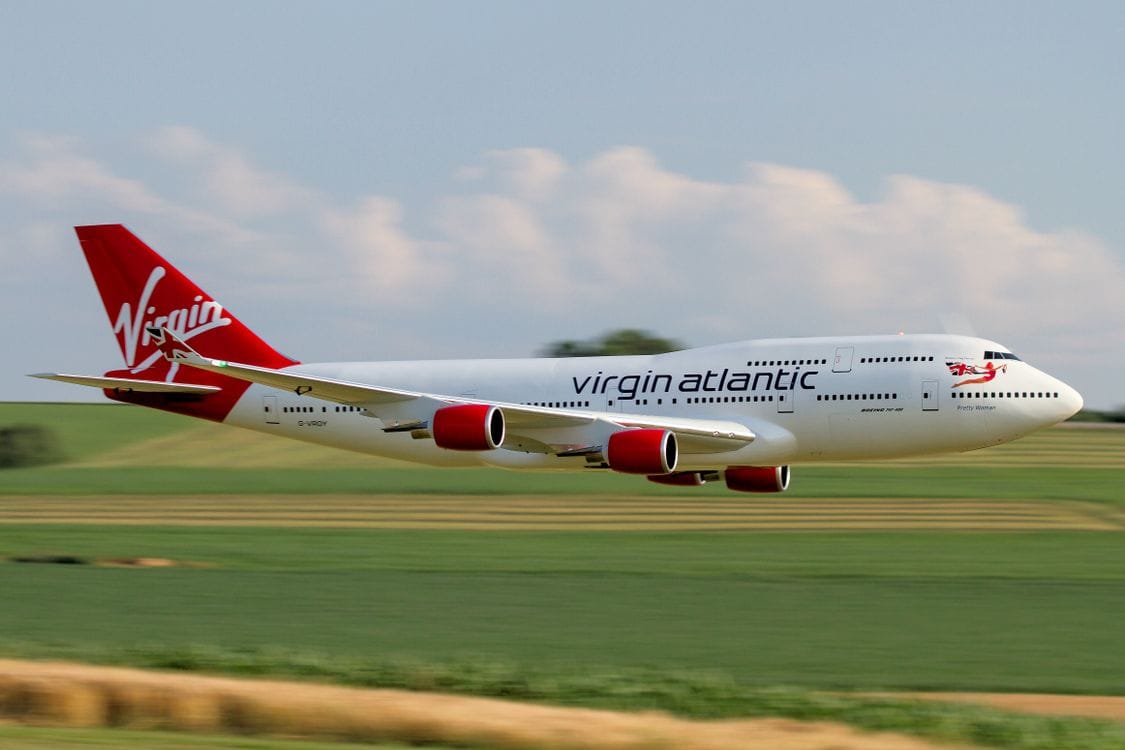 Virgin Atlantic Boeing 747 in flight over countryside on a clear day