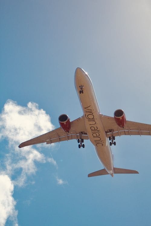Silhouette of a passenger looking out of an airplane window