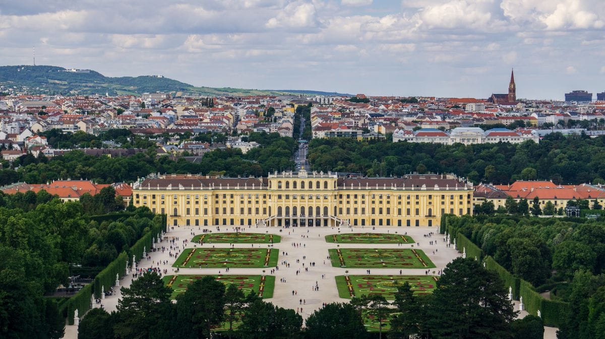 Schönbrunn Palace yellow baroque facade with formal gardens in Vienna