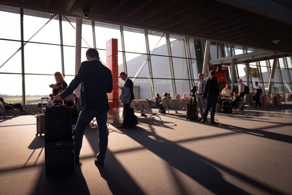 Suitcases lined up at an airport check-in desk