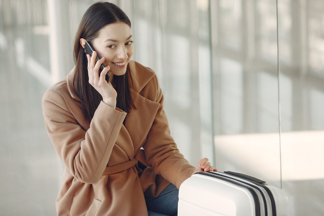 Traveller checking Wizz Air flights on phone at airport terminal