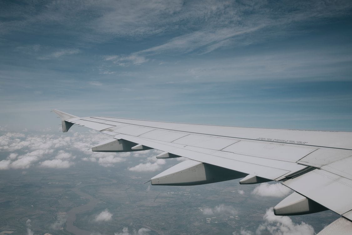 Aer Lingus aircraft wing against blue sky during a sale-period departure