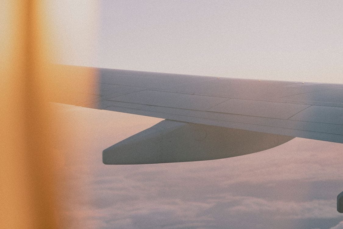 Aer Lingus aircraft wing at sunset, representing a newly released route taking off