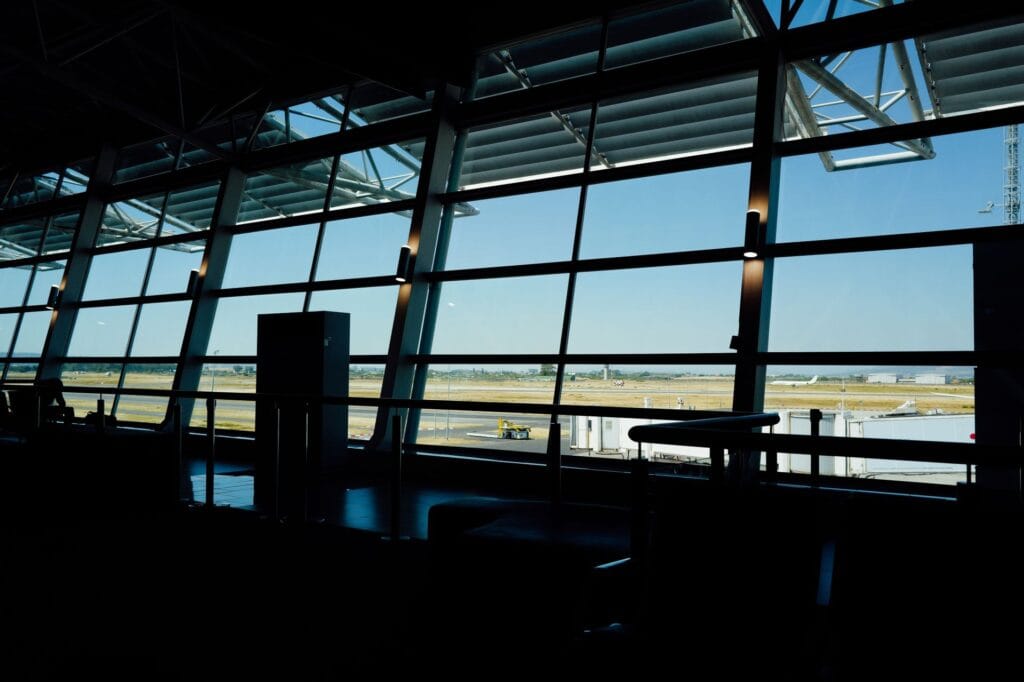 Best carry on bag for Aer Lingus — airport terminal window overlooking the runway