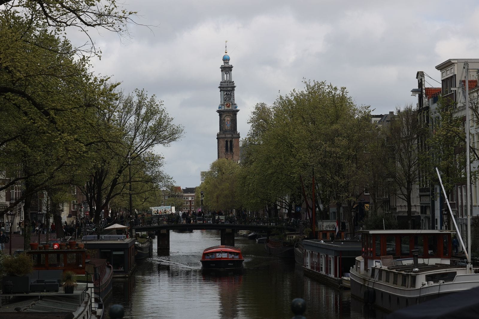 Westerkerk tower and houseboats on a canal in the Jordaan, Amsterdam