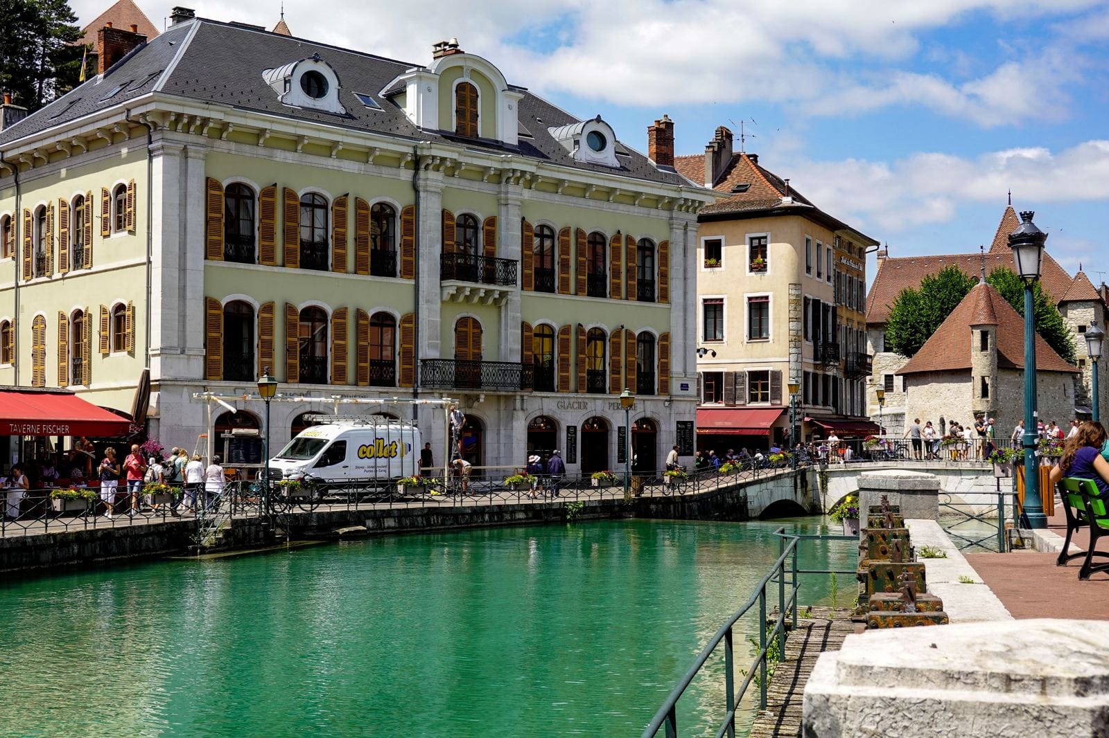 Annecy on a budget: the old town canal with colourful houses and mountains behind, France