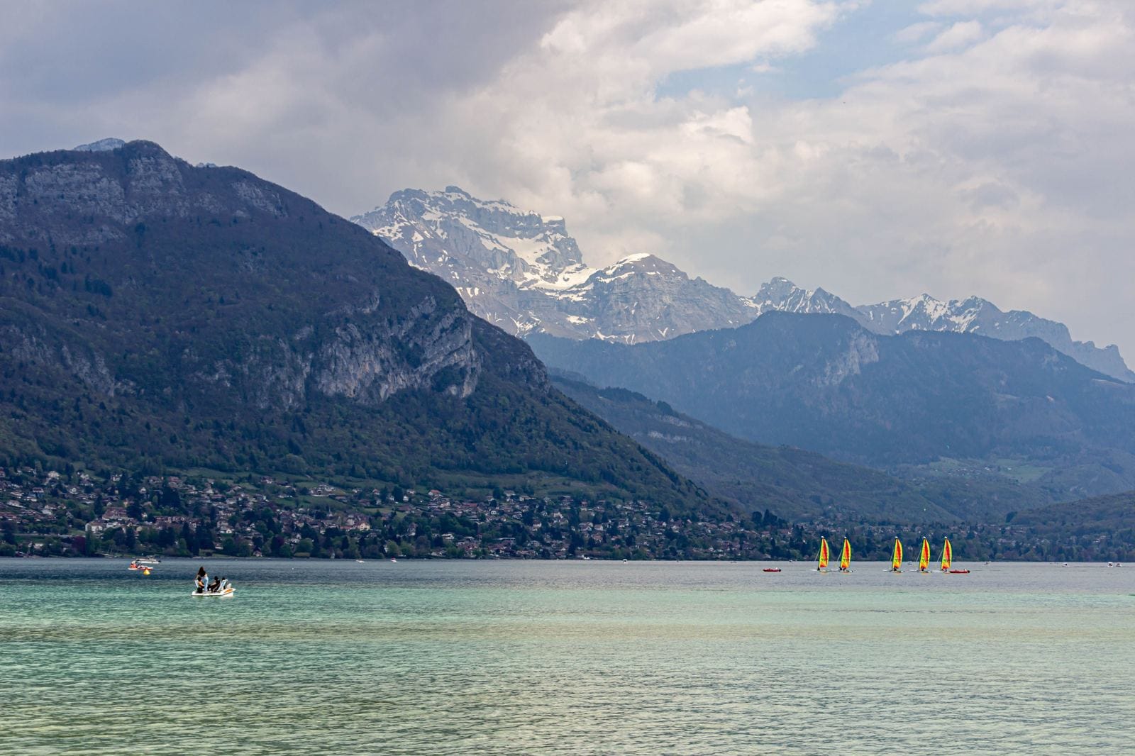 Lake Annecy with snow-capped Alpine peaks in the background
