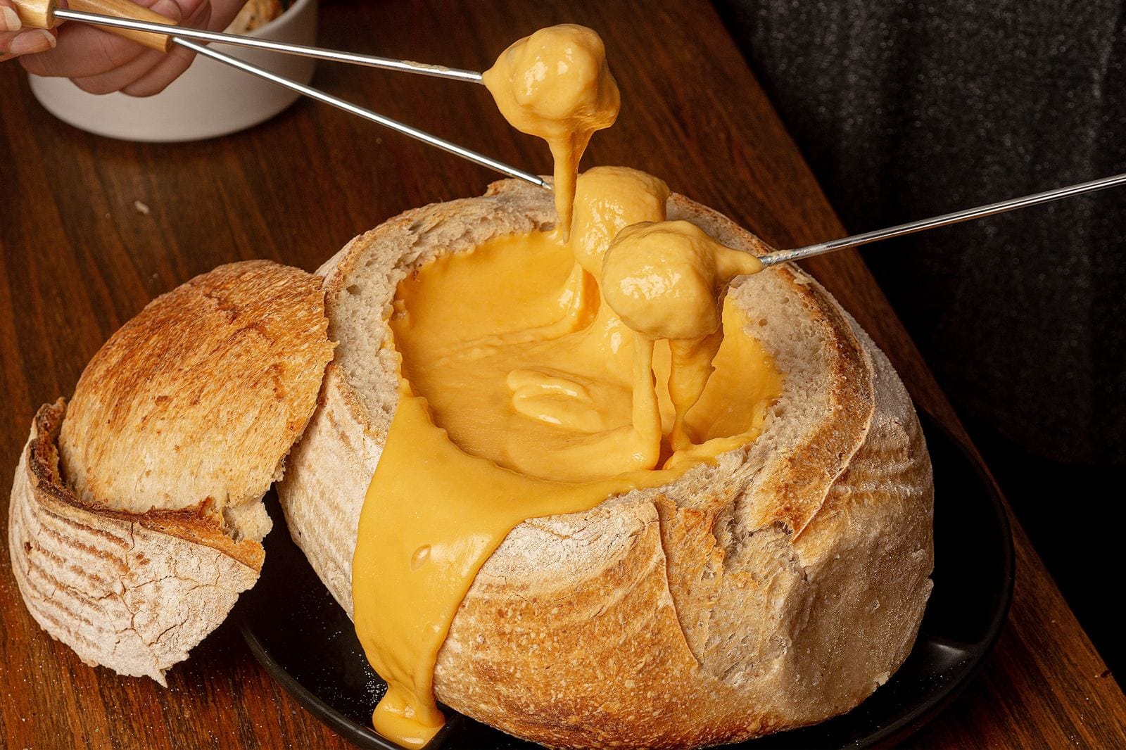 Traditional cheese fondue served in a rustic bread bowl, typical of Savoyard cuisine