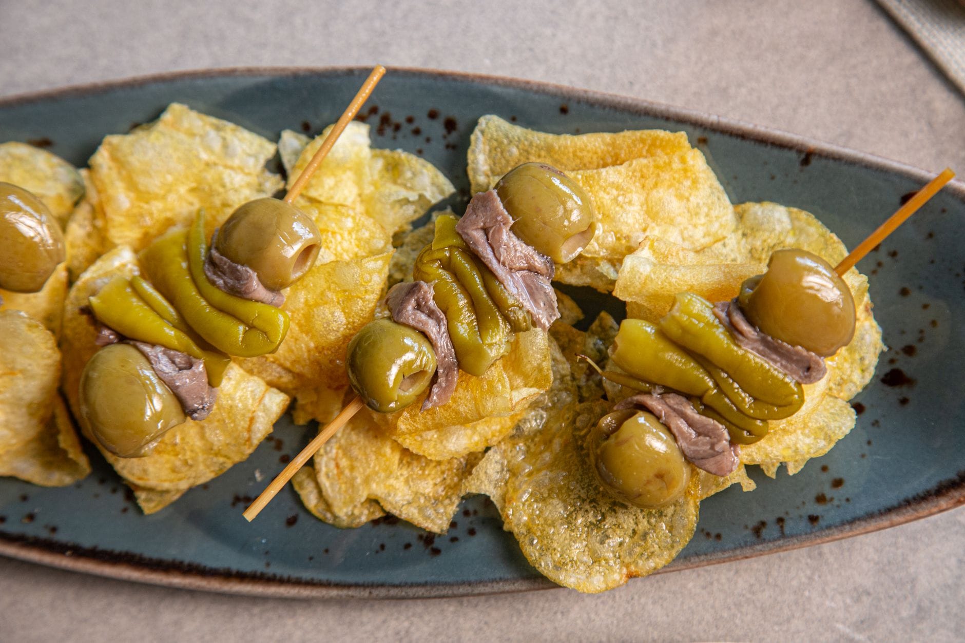 Gilda pintxos with olives, anchovies and peppers served on crisps, a classic Basque bar snack