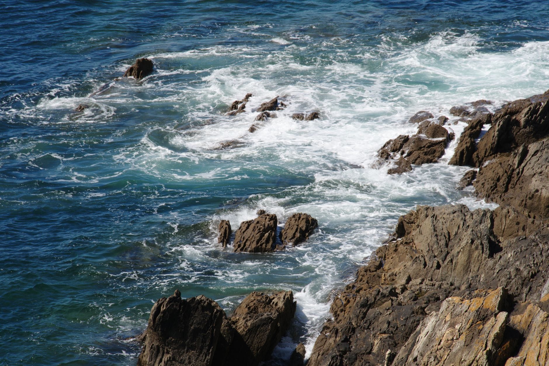 Waves crash against the Brittany coastline, home to some of the highest tides in Europe