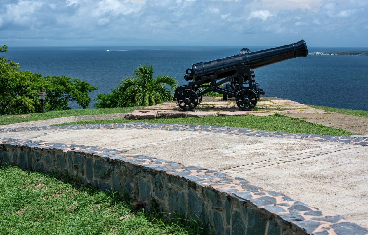 An old cannon on a stone coastal fort looking out to sea