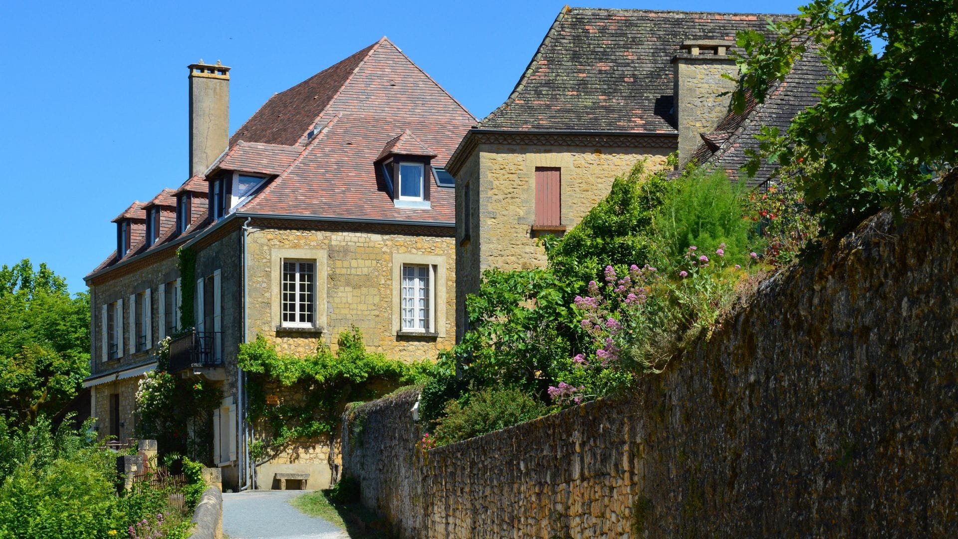 A quiet stone street in Domme, the clifftop bastide town founded in 1281
