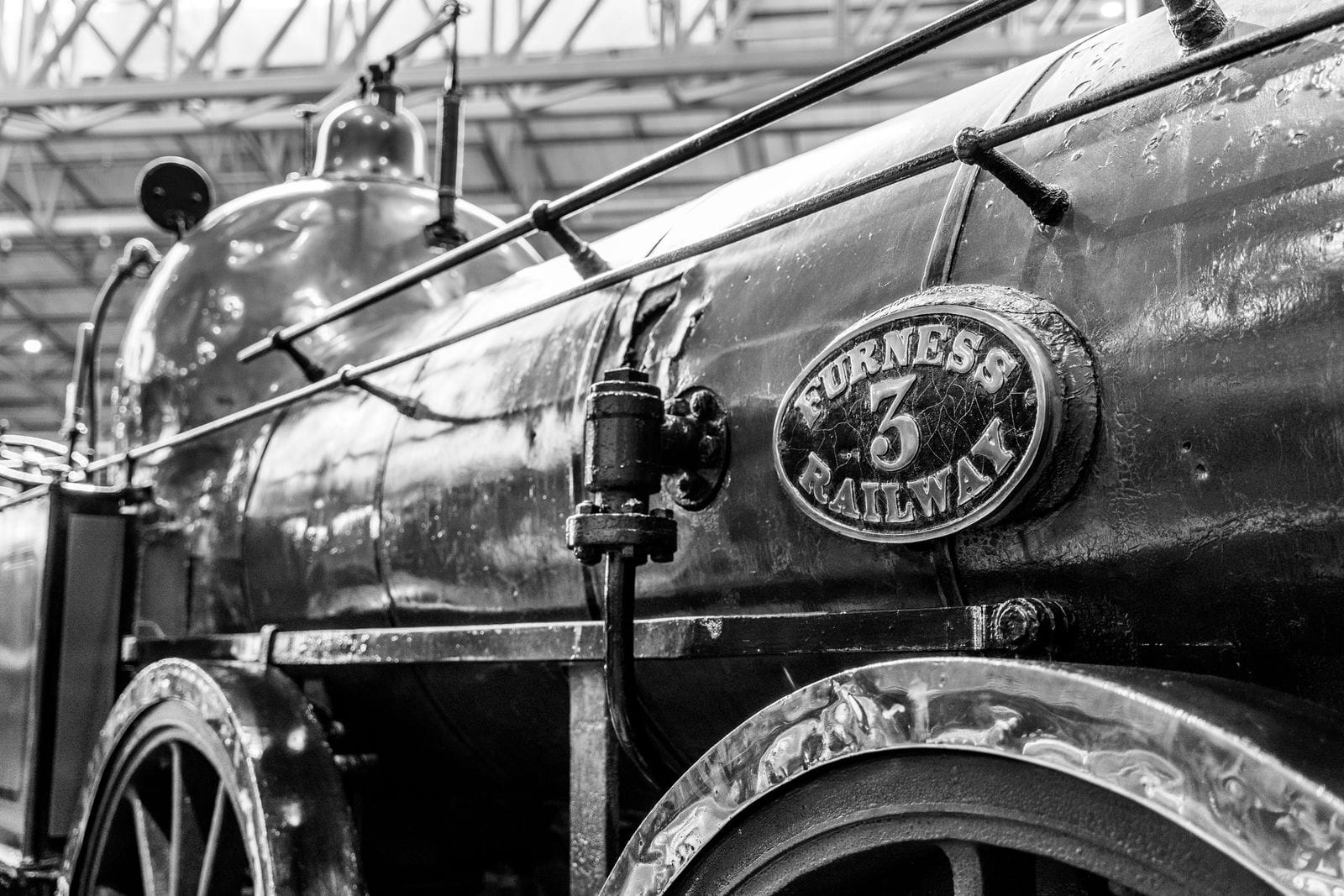 Close-up of a vintage Furness Railway locomotive nameplate, the historic line that once met the West Coast Main Line at Carnforth