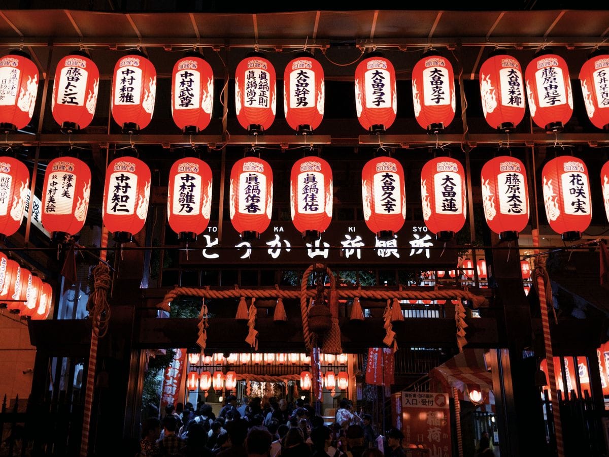 Rows of illuminated paper lanterns at a Japanese summer festival