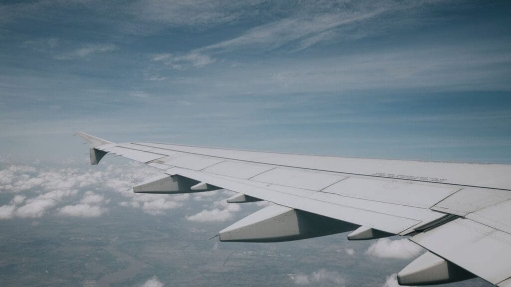 Aircraft wing over clouds, used for a KLM Amsterdam flight deal