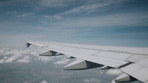 Aircraft wing over clouds, used for a KLM Amsterdam flight deal