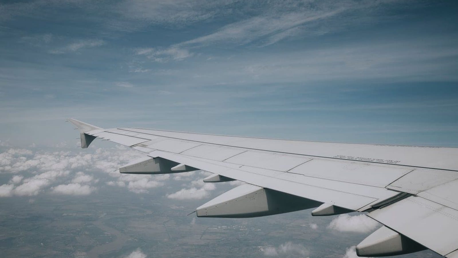 Aircraft wing over clouds, used for a KLM Amsterdam flight deal