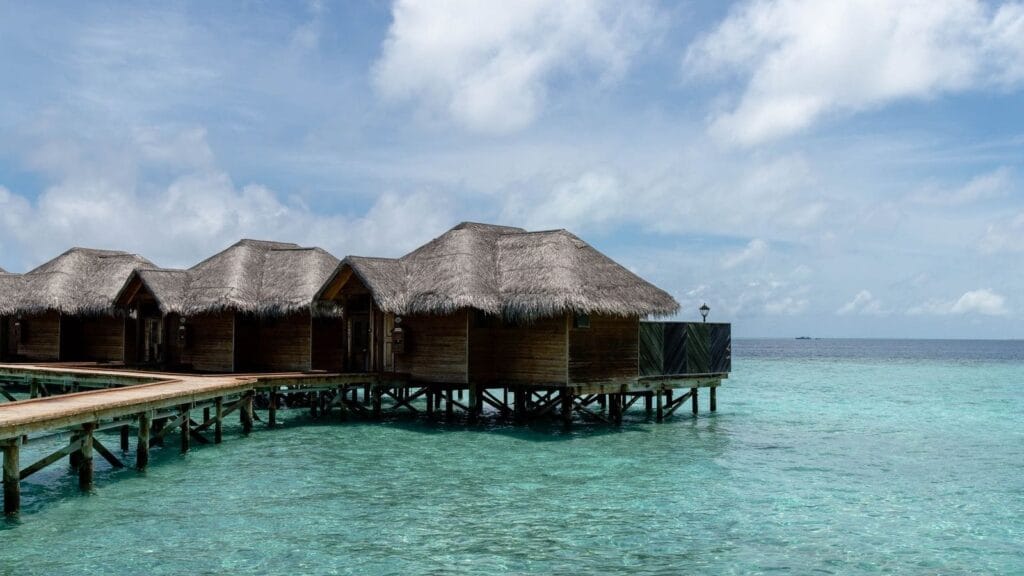 Overwater villas in the Maldives above clear turquoise water