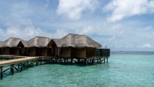 Overwater villas in the Maldives above clear turquoise water