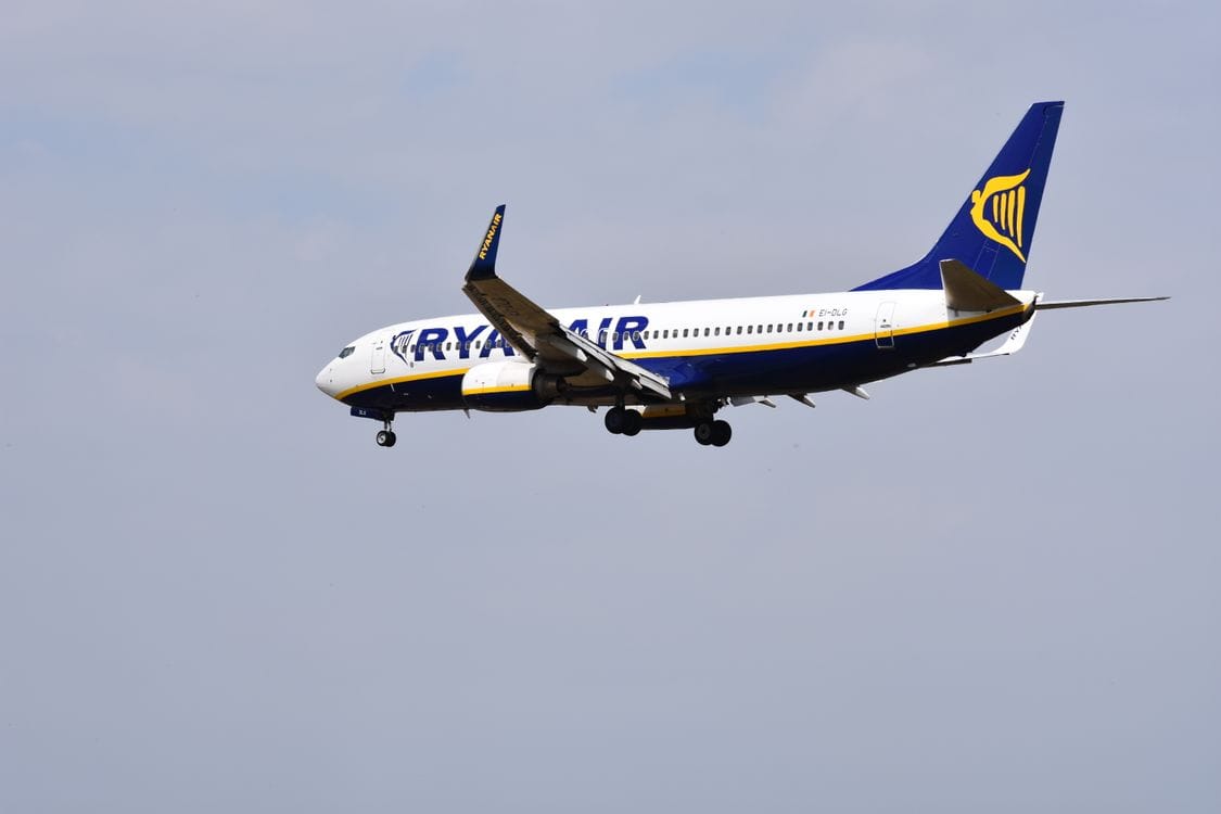 A Ryanair aircraft flying in clear blue sky, reflecting Logitravel's status as an authorised Ryanair booking agency