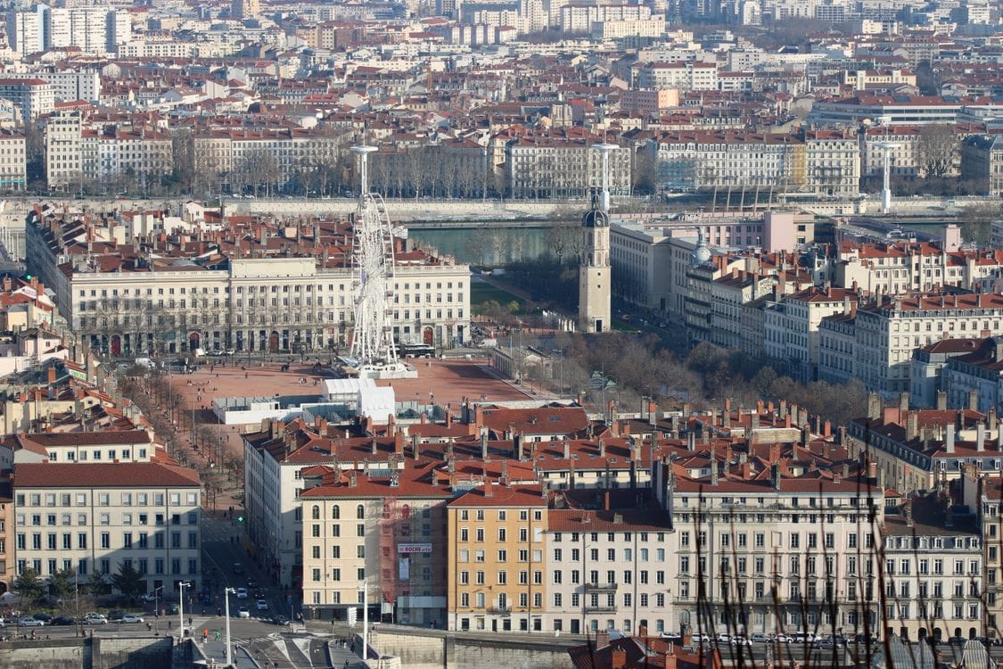 Aerial view of Lyon's Presquile district with its historic architecture and Ferris wheel