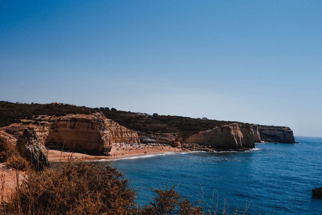 Golden limestone cliffs meeting the blue Atlantic Ocean on the Algarve coast, one of Mercury Holidays' most popular short-haul destinations
