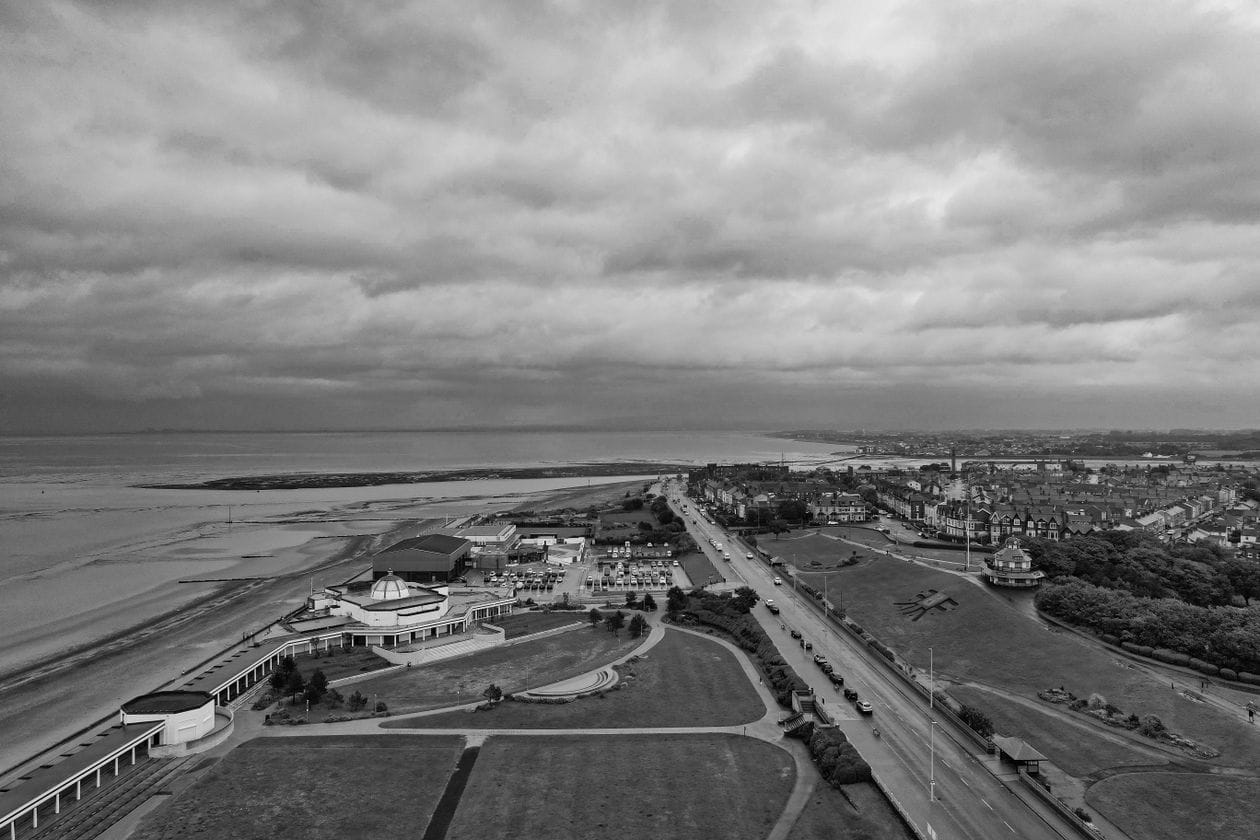 Aerial view of Morecambe promenade and bay, with the curved Art Deco Midland Hotel visible on the seafront
