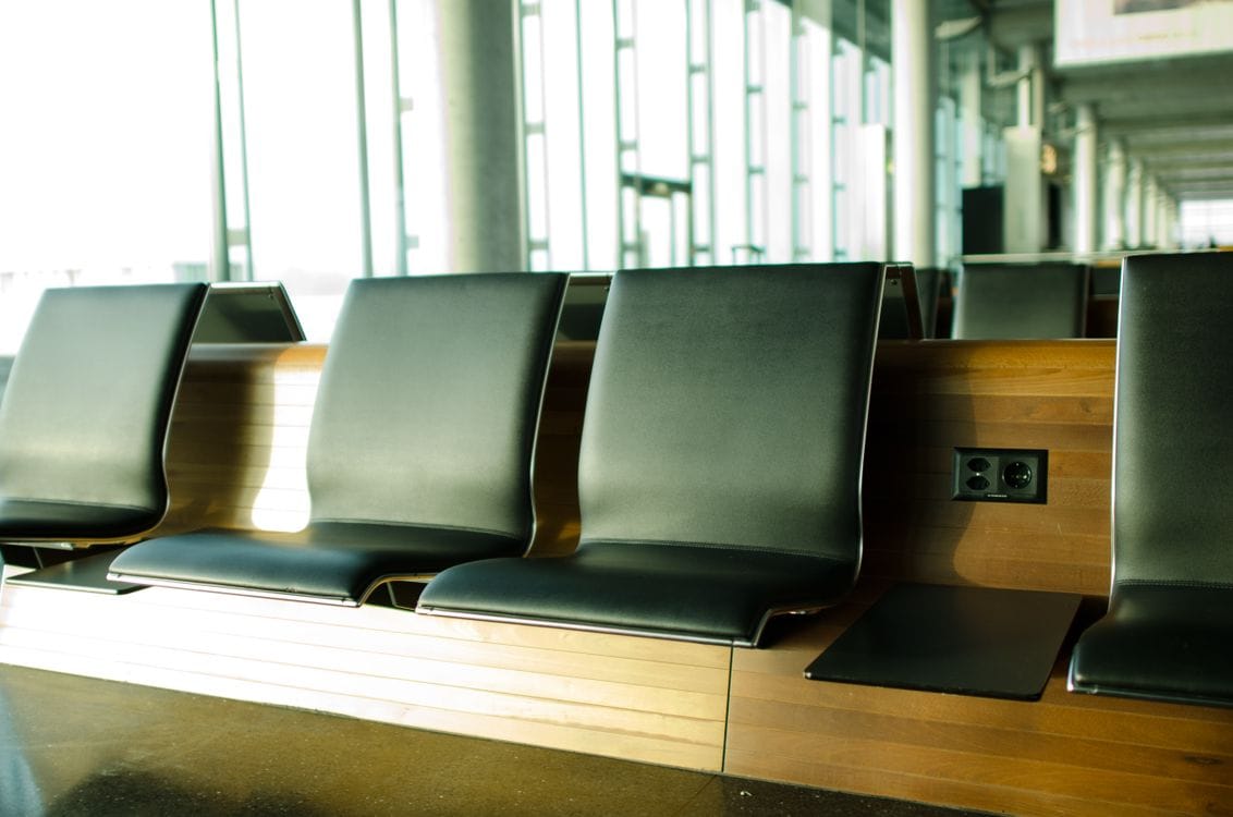Empty airport departure seating, the kind of quiet moment before a Norwegian flash sale is spotted